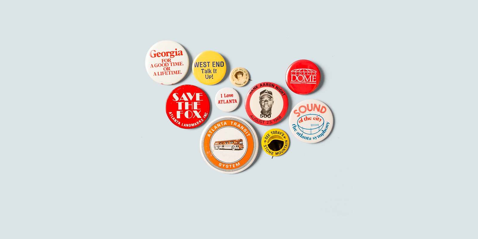 Multi-colored pin buttons with various text about Georgia on blue background