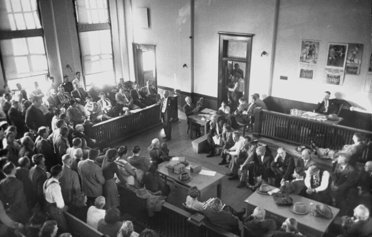 : Inside the Toombs County courthouse on January 11, 1949, for the trial of William Howell, a white man accused of killing his Black neighbor Robert Mallard.