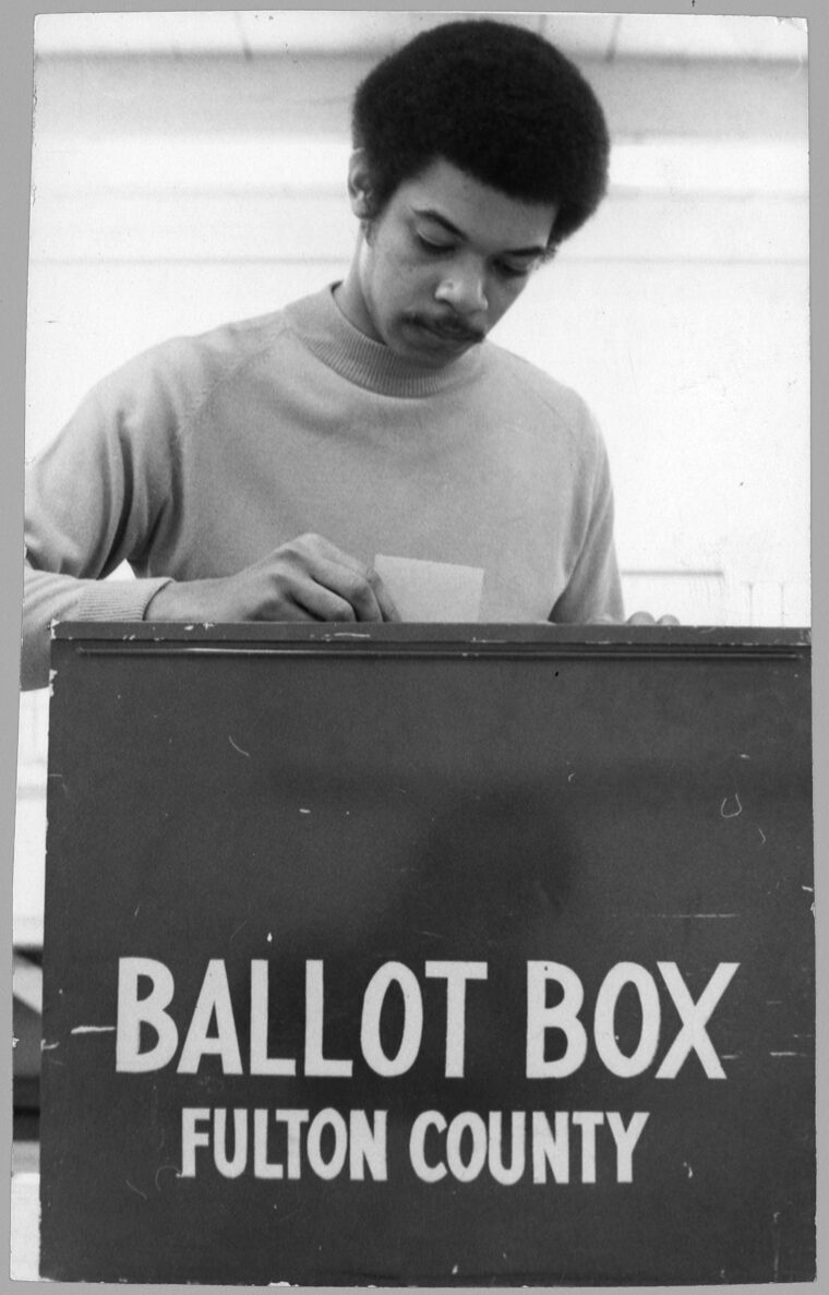 View of an unidentified man placing his vote in a Fulton County ballot box. Voter Education Project Organizational Records, Atlanta University Center, Robert W. Woodruff Library.