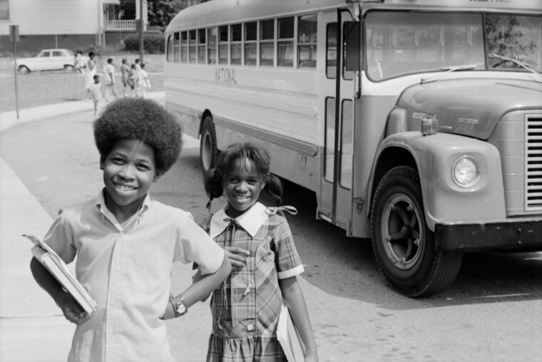 children at C. W. Hill Elementary School in the Bedford Pine neighborhood of Atlanta, Georgia, in front of a bus bound for Morningside Elementary School, part of the City of Atlanta's plan to desegregate schools through busing.