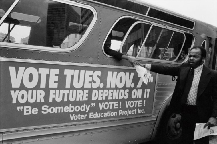 : View of John Lewis (second from left), the director of the Southern Regional Council's Voter Education Project, encouraging voter participation in downtown Atlanta, Georgia, c. 1973. Boyd Lewis, Boyd Lewis Photographs, Kenan Research Center at Atlanta History Center.